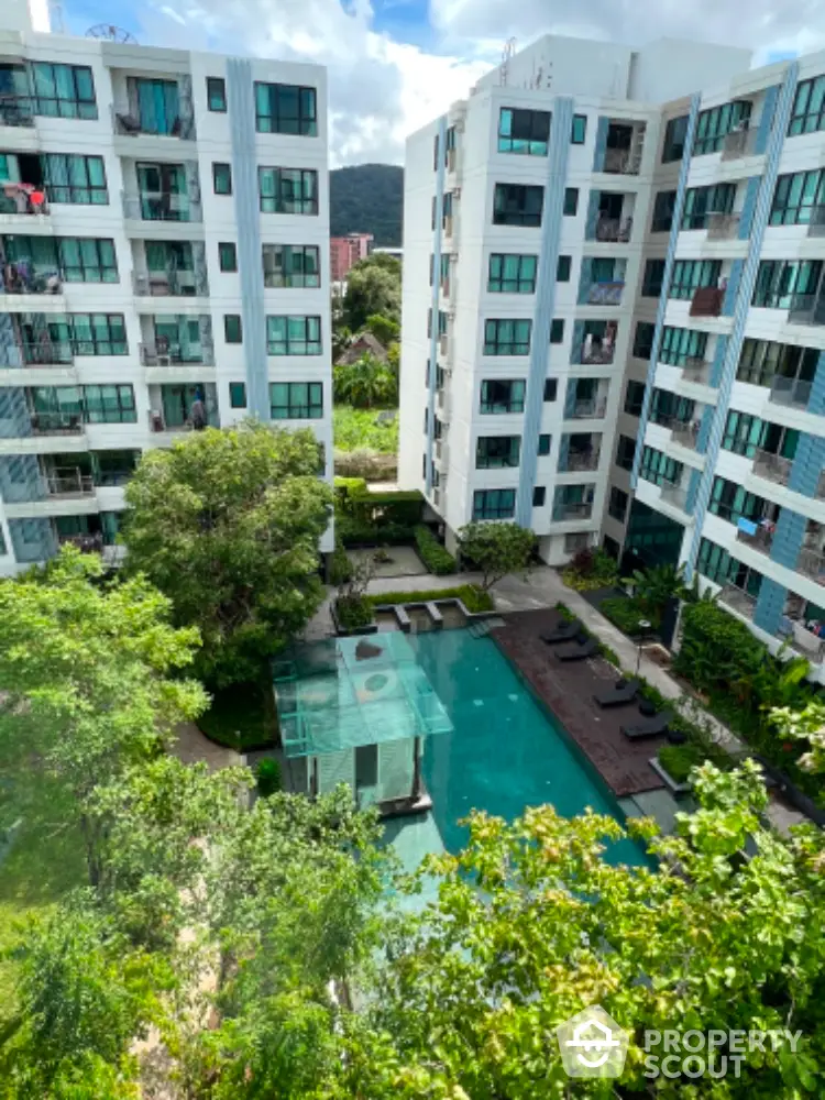 Modern condominium with pool view and lush greenery, ideal for urban living.