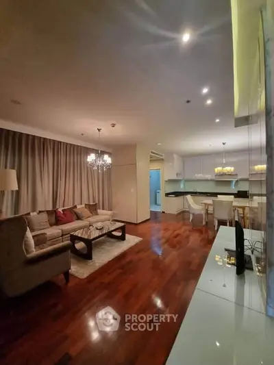 Luxurious open-plan living room with elegant decor and hardwood floors