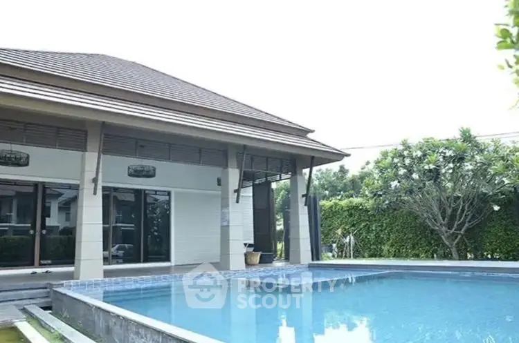 Luxurious modern house with private pool and lush garden view.