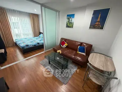 Modern studio apartment with cozy living area and bedroom, featuring stylish decor and natural light.