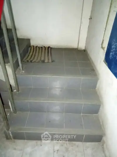 Simple staircase with tiled steps in a residential building