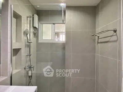 Modern bathroom with sleek shower and neutral tiles