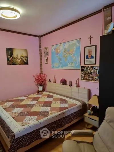 Cozy bedroom with pink walls and world map decor