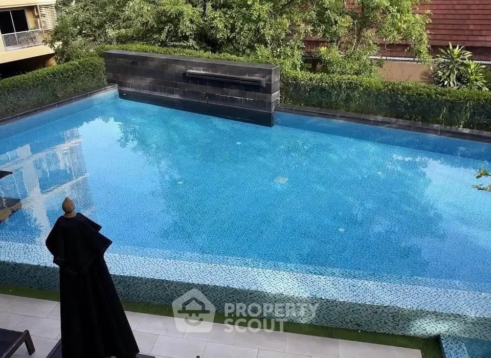 Luxurious outdoor pool with serene surroundings and lush greenery