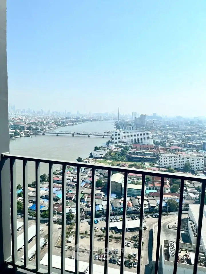 Stunning high-rise balcony view overlooking river and cityscape, perfect for urban living enthusiasts.