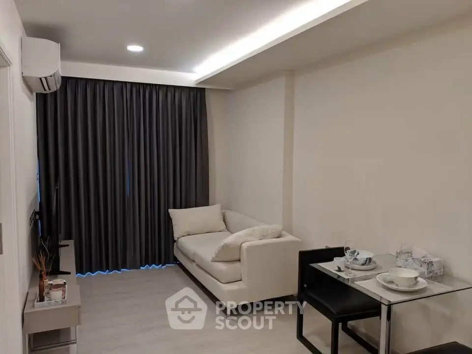 Modern living room with cozy sofa and dining area in stylish apartment.