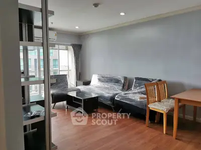 Spacious living room with modern furniture and large windows in a stylish apartment.