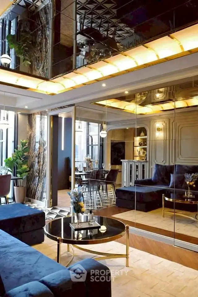 Luxurious living room with mirrored walls and elegant decor, featuring plush seating and ambient lighting.