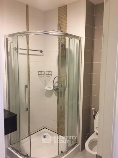 Modern bathroom with glass shower enclosure and sleek design.