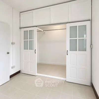 Spacious walk-in closet with sliding doors in modern home