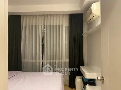 Cozy bedroom with modern air conditioning and elegant curtains