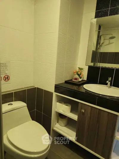 Modern bathroom with sleek design and stylish fixtures in a contemporary apartment.
