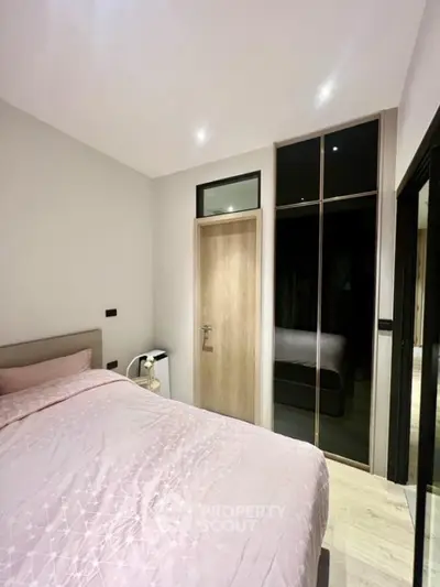 Cozy modern bedroom with stylish decor and ample natural light