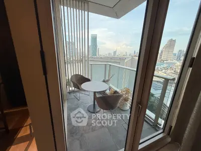 Stunning city view from a modern balcony with cozy seating area.