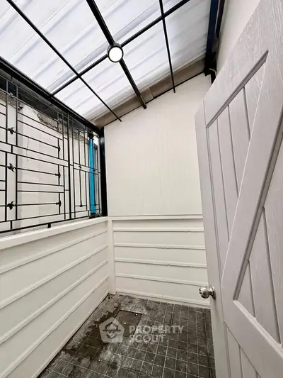 Charming enclosed balcony with modern design and natural light