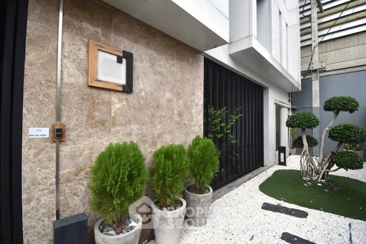 Modern building exterior with stylish landscaping and stone facade
