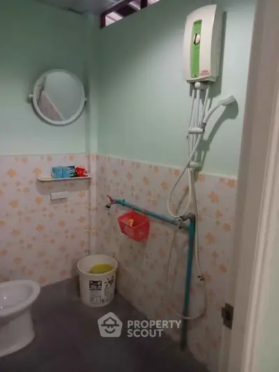 Cozy bathroom with floral tiles and modern shower heater