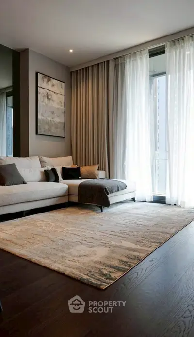 Modern living room with elegant decor and floor-to-ceiling windows.