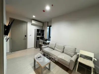 Modern living room with cozy sofa and study area in a stylish apartment.
