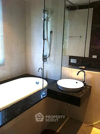 Luxurious modern bathroom with sleek design and elegant fixtures, featuring a stylish bathtub and contemporary sink.