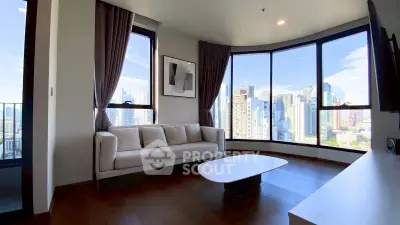 Luxurious living room with panoramic city views and modern furnishings in high-rise apartment.