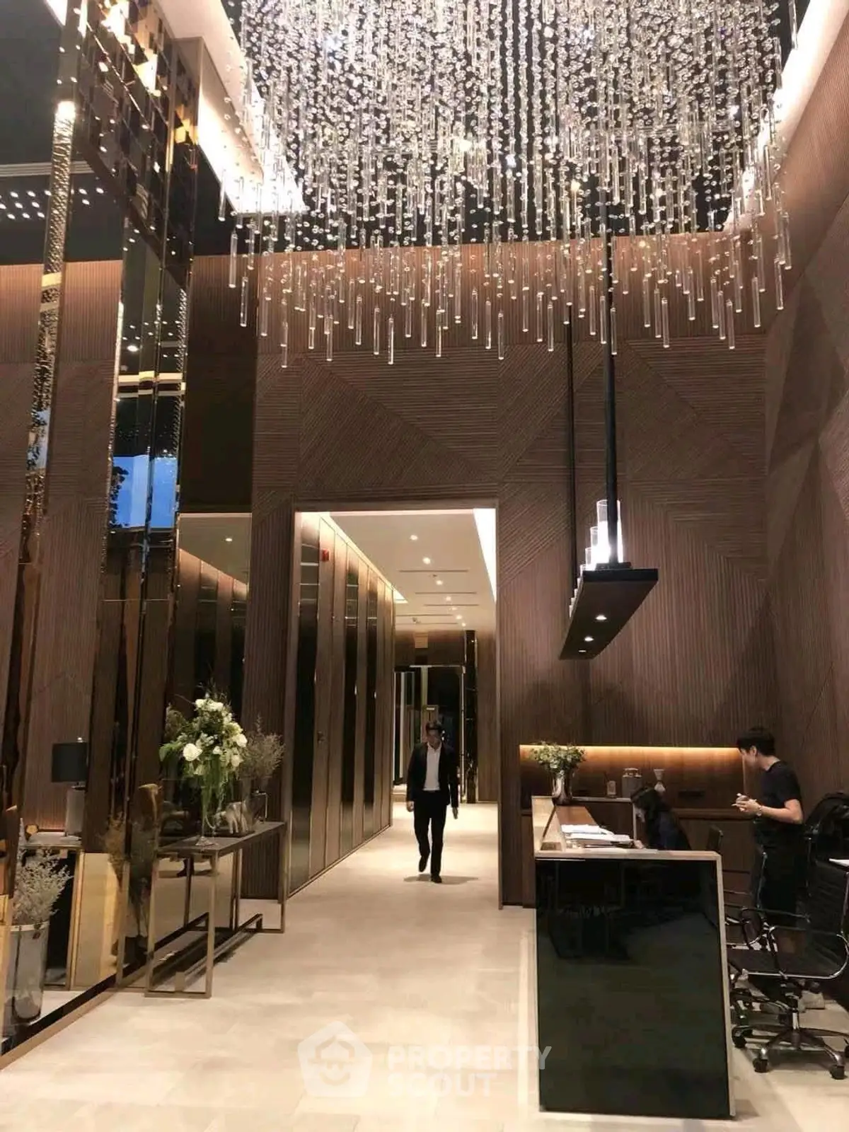 Luxurious modern building entrance with elegant chandelier and sleek design