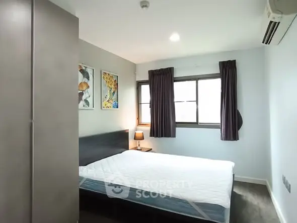 Cozy bedroom with modern decor and ample natural light