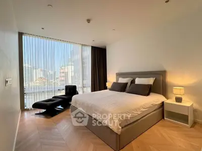 Luxurious bedroom with modern decor and stunning city view, featuring elegant furnishings and floor-to-ceiling windows.