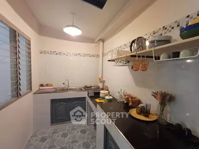 Charming kitchen with modern open shelving and sleek countertops, perfect for culinary enthusiasts.
