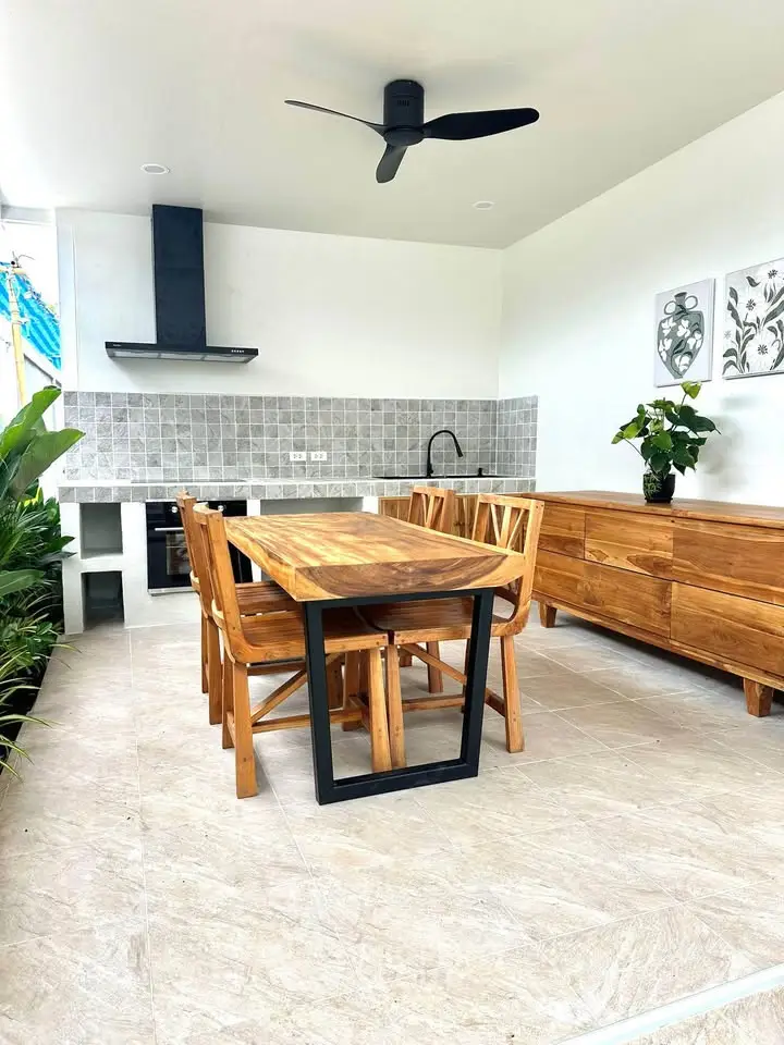 Stylish outdoor dining area with wooden furniture and modern decor