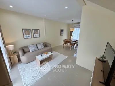 Modern living room with cozy sofa and dining area in open layout apartment