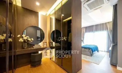 Luxurious bedroom with elegant mirrored wardrobe and stylish decor