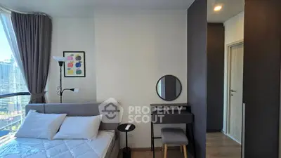 Modern bedroom with city view, featuring stylish decor and natural light.