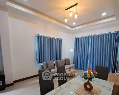 Modern living room with stylish lighting and elegant blue curtains