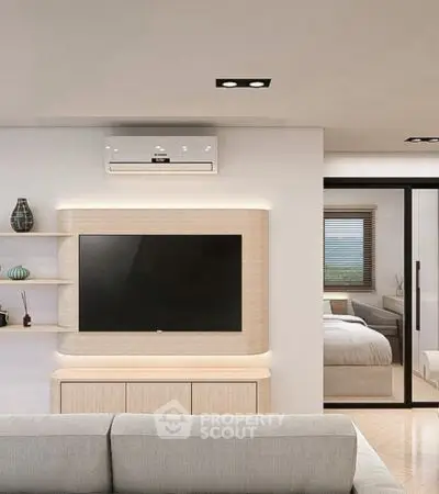Modern living room with sleek TV setup and view into a cozy bedroom