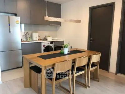 Modern kitchen with wooden dining set and sleek appliances