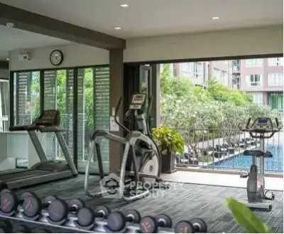Modern gym with pool view in luxury apartment complex