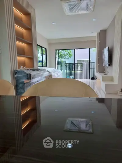 Modern living room with large windows and sleek furniture