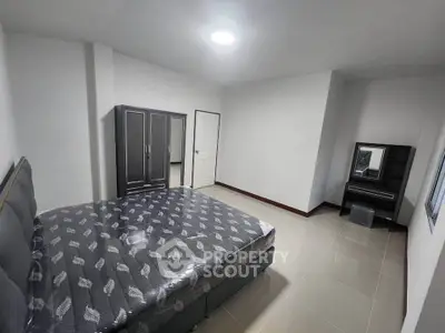 Spacious bedroom with modern furniture and ample natural light