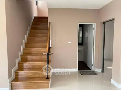 Modern interior with wooden staircase and tiled flooring in a bright home