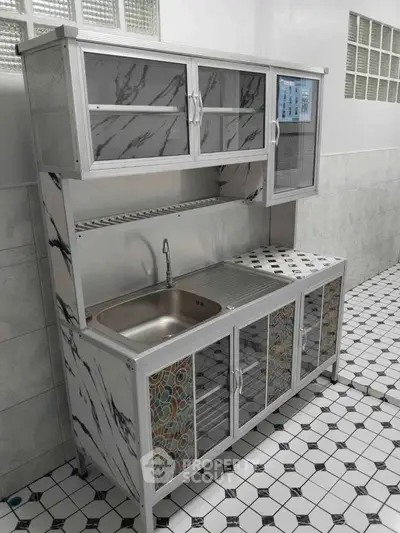 Modern kitchen sink with stylish cabinetry and marble finish in a sleek design.