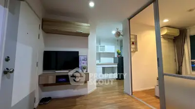 Modern living room with sleek TV setup and wooden flooring