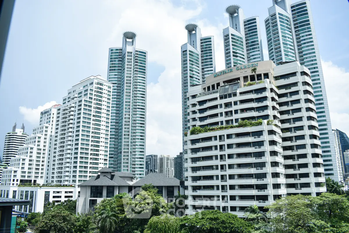 Stunning cityscape view of modern high-rise buildings with lush greenery in urban setting.