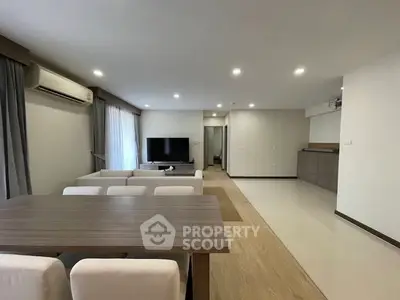 Spacious modern living room with dining area and sleek interior design