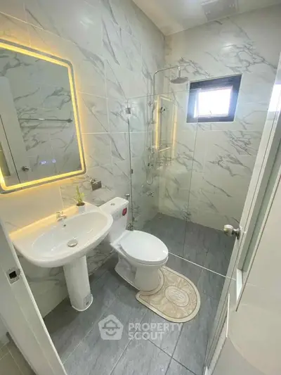 Modern bathroom with elegant marble tiles and sleek fixtures