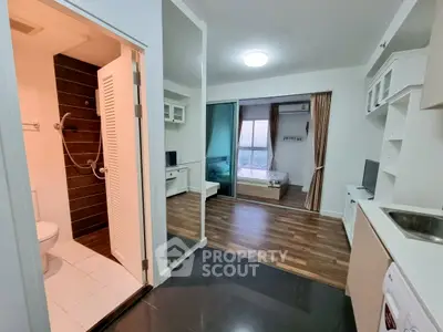 Modern apartment interior with open layout, featuring a cozy bedroom, sleek kitchen, and stylish bathroom.