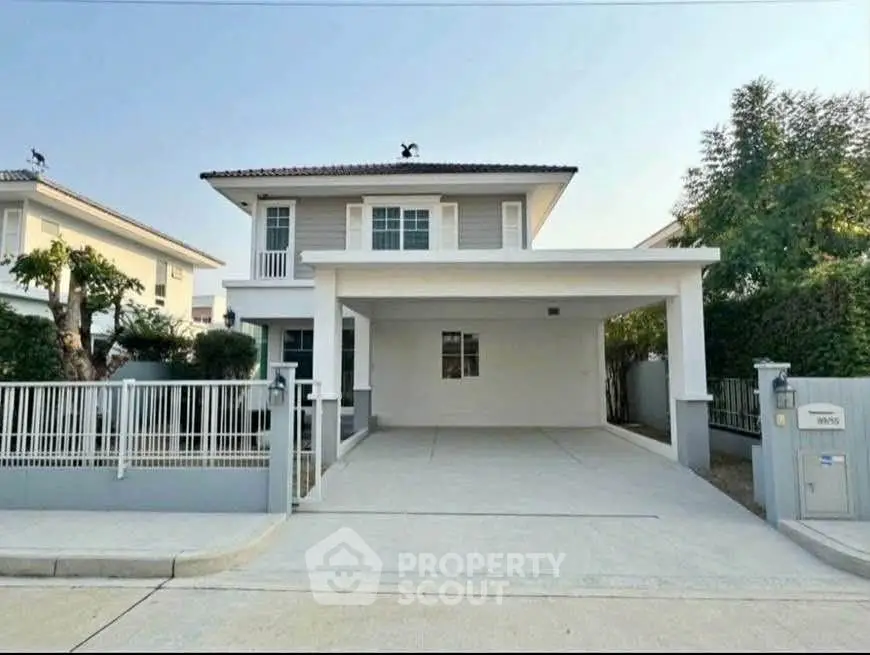 Charming two-story house with spacious driveway and modern exterior design in a serene neighborhood.
