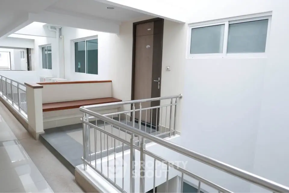 Modern apartment corridor with sleek design and natural lighting