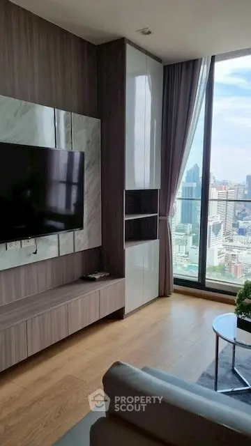 Modern living room with city view and sleek TV setup
