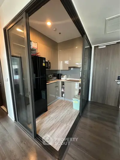 Modern compact kitchen with sleek cabinetry and appliances